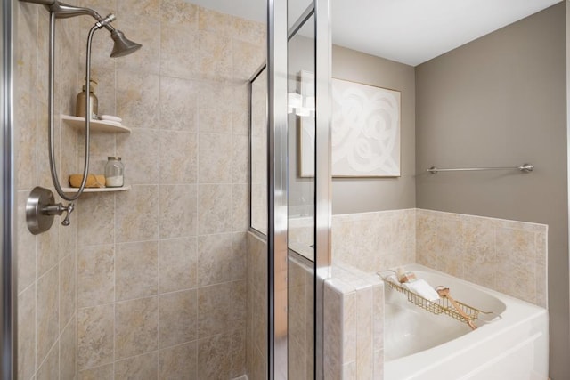 bathroom featuring a shower stall and a garden tub