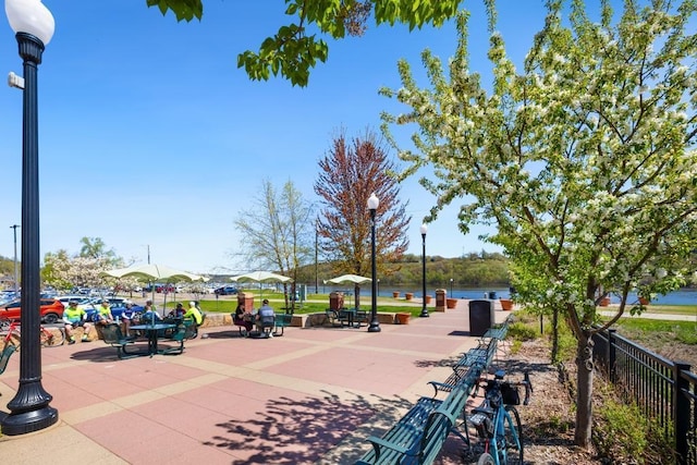 view of home's community featuring fence