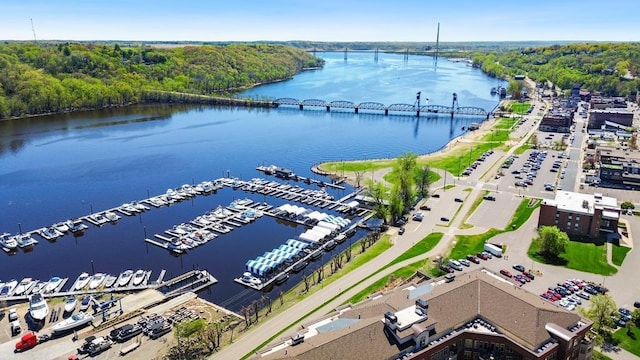 aerial view featuring a forest view and a water view
