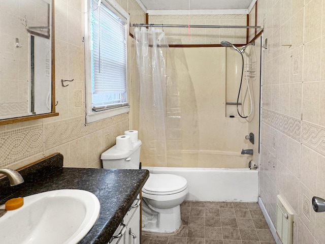 bathroom featuring tile walls, shower / bath combo with shower curtain, vanity, and plenty of natural light