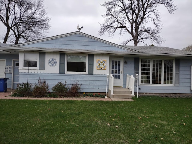 122 10th St, Madison, MN 56256 - view of front of property with a front yard and board and batten siding