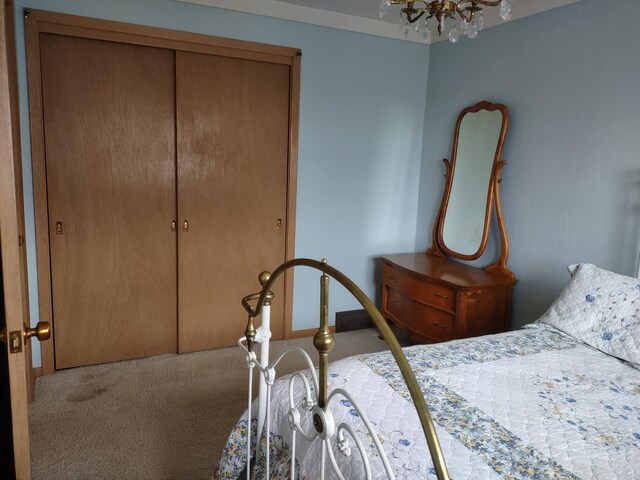 122 10th St, Madison, MN 56256 - bedroom with carpet flooring, a chandelier, and a closet