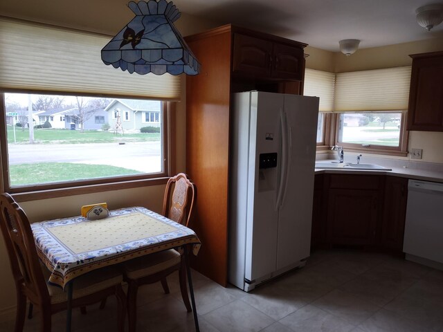122 10th St, Madison, MN 56256 - kitchen featuring white appliances, a sink, light tile patterned floors, and light countertops