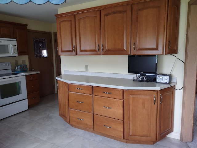 122 10th St, Madison, MN 56256 - kitchen with white appliances, light countertops, and brown cabinetry