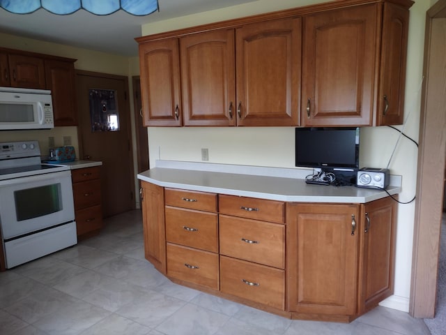 122 10th St, Madison, MN 56256 - kitchen featuring white appliances, light countertops, and brown cabinetry
