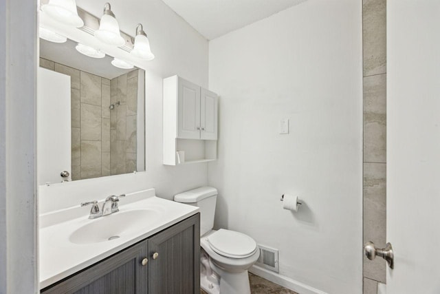 8040 Xenia Ave N, Brooklyn Park, MN 55443 - full bath with toilet, vanity, a tile shower, and baseboards