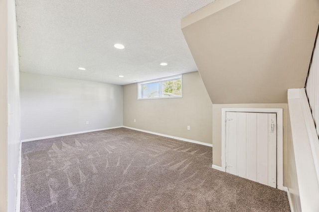 8040 Xenia Ave N, Brooklyn Park, MN 55443 - basement featuring carpet, baseboards, a textured ceiling, and recessed lighting