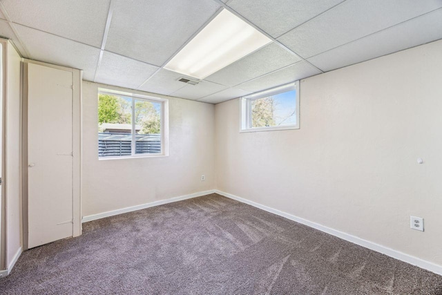 8040 Xenia Ave N, Brooklyn Park, MN 55443 - carpeted empty room with a paneled ceiling, baseboards, and plenty of natural light