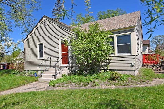 bungalow-style home with roof with shingles