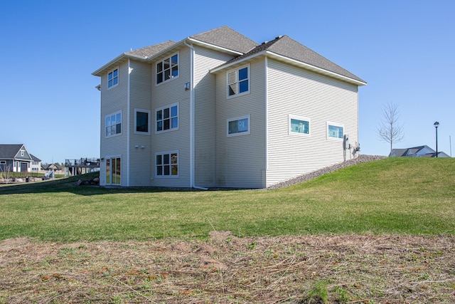 view of property exterior featuring a lawn