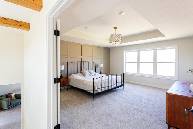 bedroom with baseboards, a tray ceiling, recessed lighting, and light colored carpet