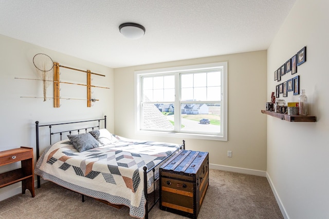carpeted bedroom with baseboards and a textured ceiling