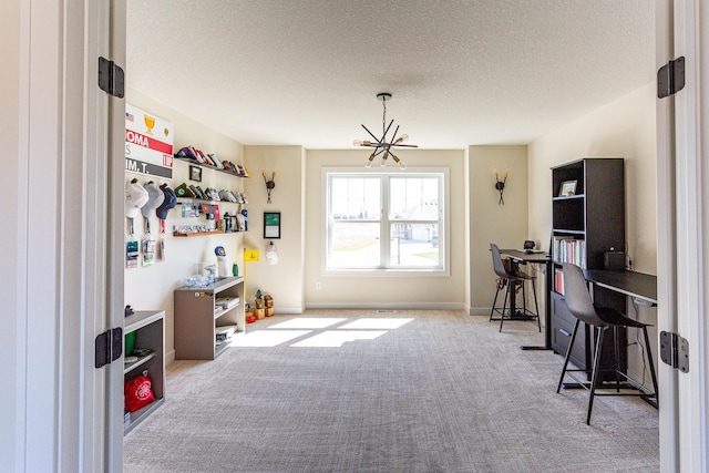 home office featuring a textured ceiling, carpet, and a notable chandelier