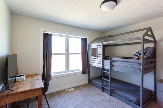 carpeted bedroom with baseboards and visible vents