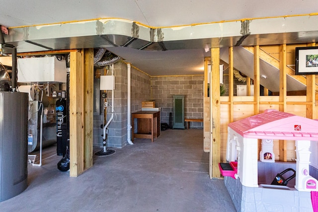 unfinished below grade area with water heater and concrete block wall