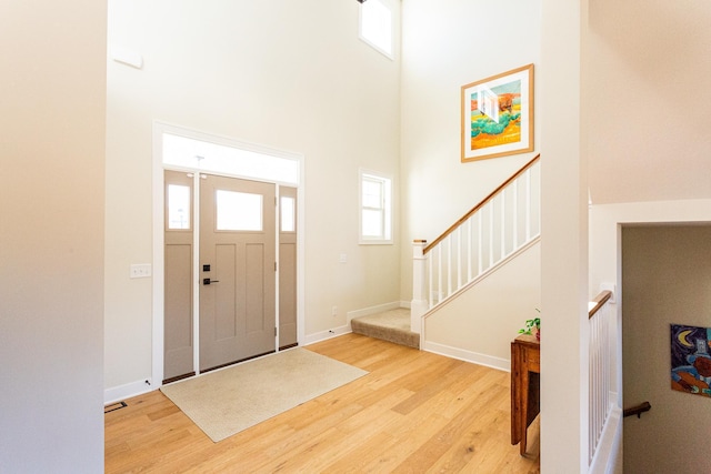 4465 167th Ave NW, Andover, MN 55304 - entryway with light wood-style flooring, a high ceiling, and baseboards