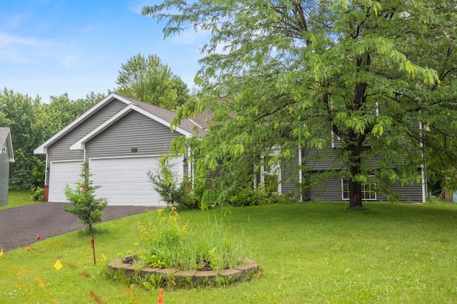 1312 Widgeon Way, Buffalo, MN 55313 - view of green lawn with driveway and a garage