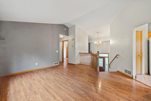 1312 Widgeon Way, Buffalo, MN 55313 - empty room featuring wood finished floors, a chandelier, and lofted ceiling