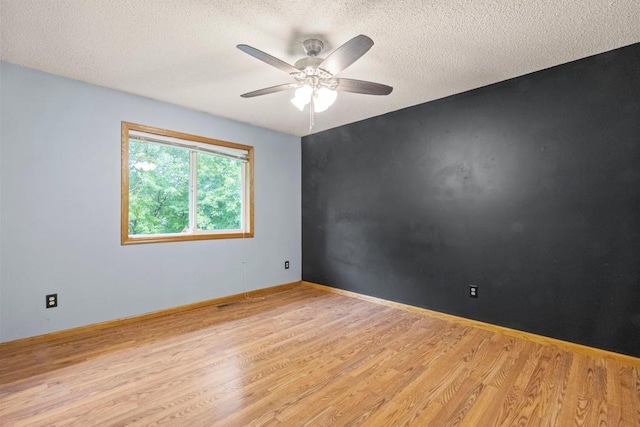 1312 Widgeon Way, Buffalo, MN 55313 - unfurnished room featuring wood finished floors, ceiling fan, and a textured ceiling