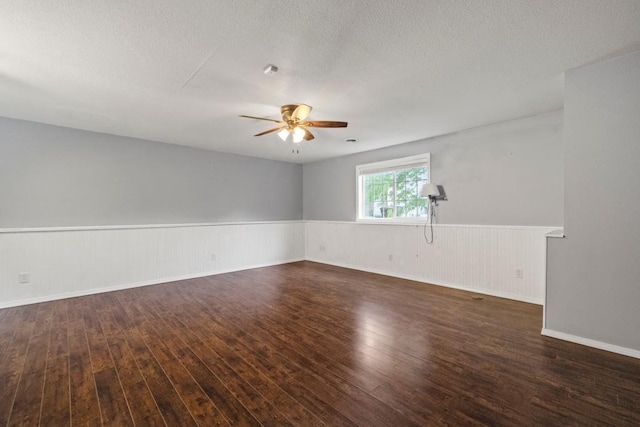 1312 Widgeon Way, Buffalo, MN 55313 - unfurnished room with ceiling fan, hardwood / wood-style flooring, a wainscoted wall, and a textured ceiling