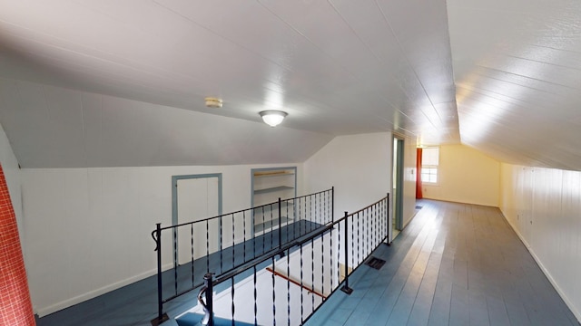 bonus room with baseboards, hardwood / wood-style flooring, and lofted ceiling