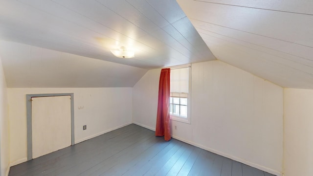 bonus room featuring wood-type flooring, baseboards, and lofted ceiling