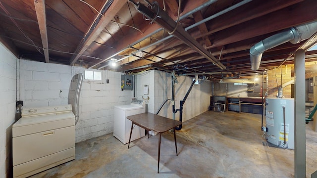 basement featuring gas water heater, electric panel, and washing machine and dryer