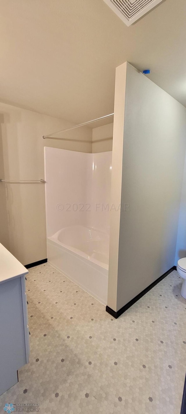 full bathroom with vanity, shower / bath combination, tile patterned floors, visible vents, and baseboards