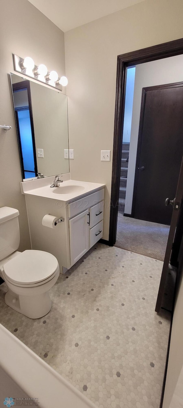bathroom with toilet and vanity