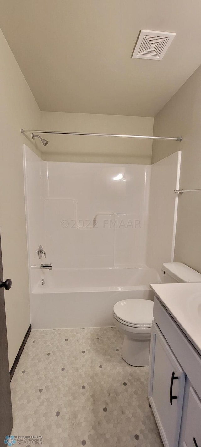 bathroom featuring washtub / shower combination, vanity, tile patterned floors, toilet, and visible vents