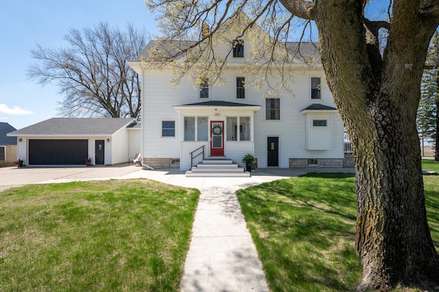 view of front of home with a front yard, concrete driveway, and entry steps