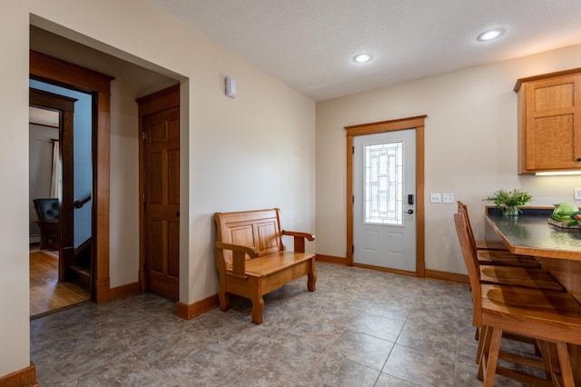 foyer with baseboards and recessed lighting