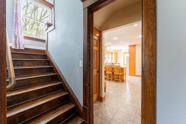 stairway with healthy amount of natural light, tile patterned flooring, recessed lighting, and baseboards
