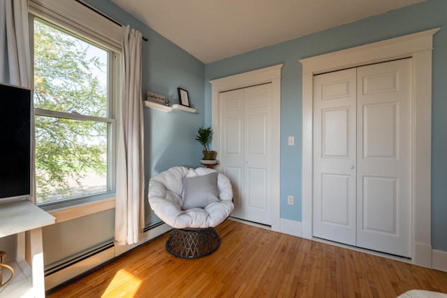 sitting room with healthy amount of natural light and wood finished floors