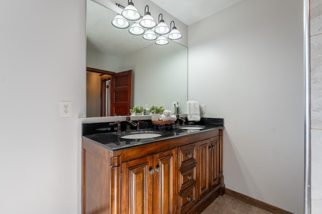 bathroom featuring double vanity, tile patterned floors, and baseboards