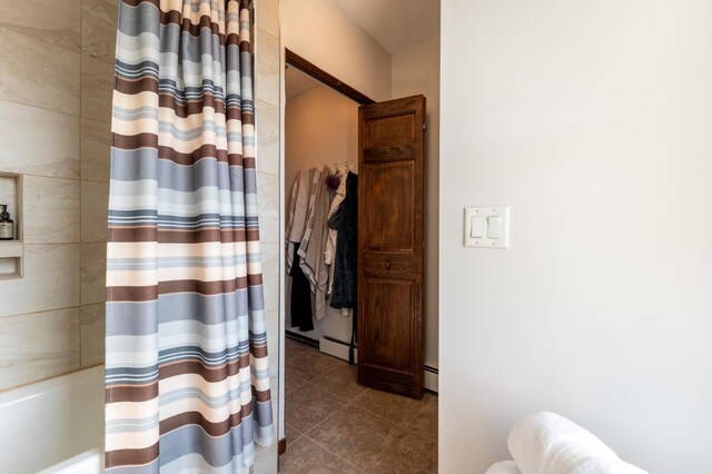 bathroom with tile patterned floors and shower / bath combo