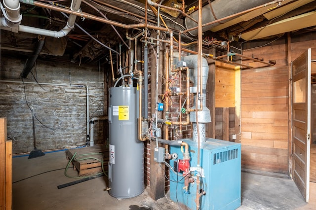 utilities featuring electric water heater and a heating unit