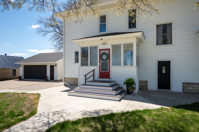 view of front of home featuring concrete driveway, a garage, and entry steps