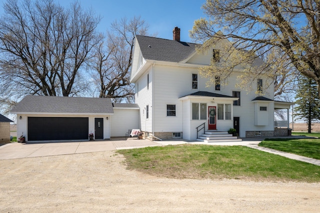 view of front of home with concrete driveway, entry steps, a front lawn, a chimney, and a shingled roof