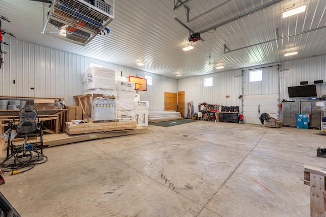 garage featuring a garage door opener and a workshop area