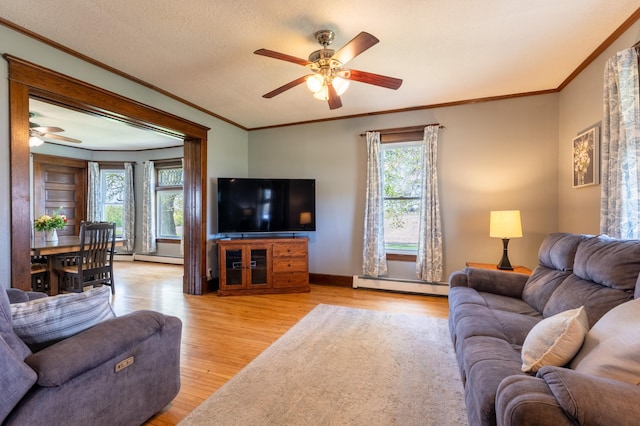 living room featuring ceiling fan, a baseboard radiator, light wood finished floors, and ornamental molding