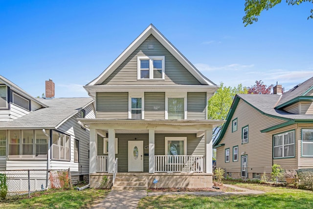 american foursquare style home featuring covered porch