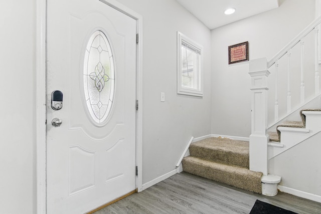 entrance foyer with stairs, baseboards, and light wood-type flooring