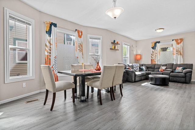 dining space featuring wood finished floors and baseboards