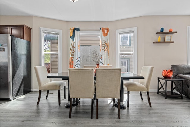 dining room with light wood-style flooring and baseboards
