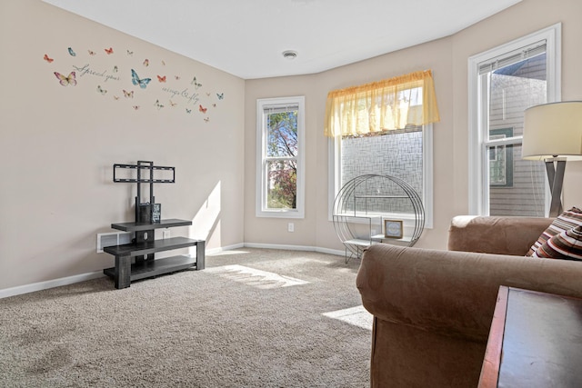 sitting room featuring carpet floors and baseboards