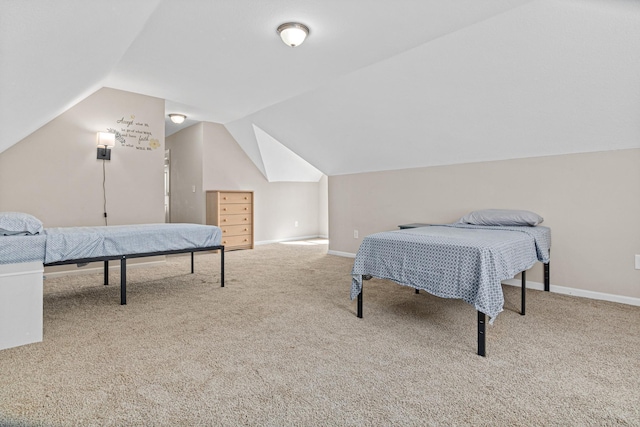 carpeted bedroom with baseboards and vaulted ceiling