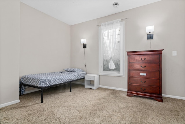 carpeted bedroom featuring baseboards
