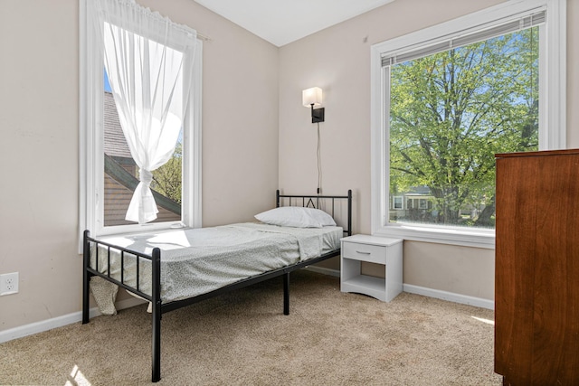 carpeted bedroom featuring baseboards