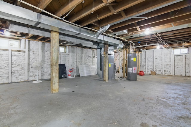 below grade area featuring water heater and heating unit
